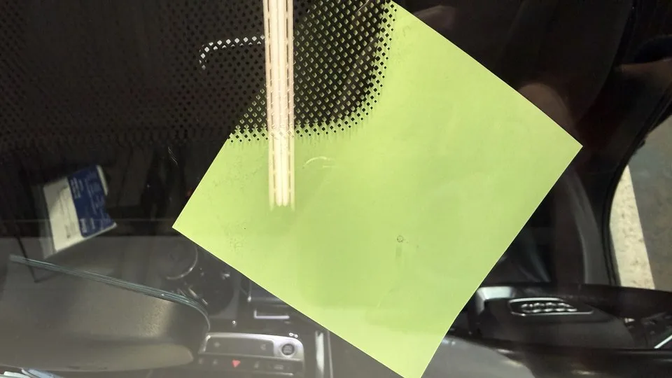 The same chip after repair — nearly invisible against the glass